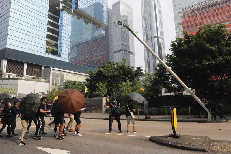 2019年8月24日，香港「反送中」觀塘遊行，示威者拆除疑似裝有中國監控系統的智慧燈柱（AP）