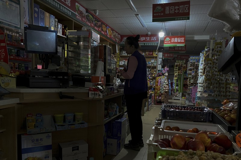 中國大停電。中國遼寧省,瀋陽一處商店因為停電,只能使用柴油發電機供電的燈泡為客戶照明。(美聯社) 中國大停電。中國遼寧省,瀋陽一處商店因為停電,只能使用柴油發電機供電的燈泡為客戶照明。(美聯社)