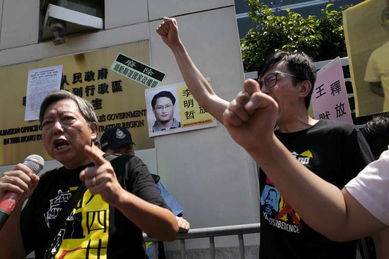 香港支聯會及社民連11日舉行示威遊行,聲援在中國被捕的維權人士及台灣非政府組織工作者李明哲。(AP) 香港支聯會及社民連11日舉行示威遊行,聲援在中國被捕的維權人士及台灣非政府組織工作者李明哲。(AP)