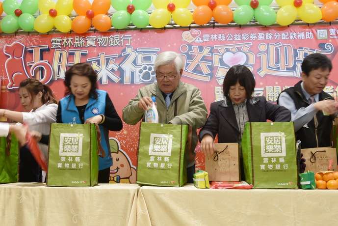 雲林縣長李進勇一一將物資裝入物資袋中。（圖／雲林縣政府提供）