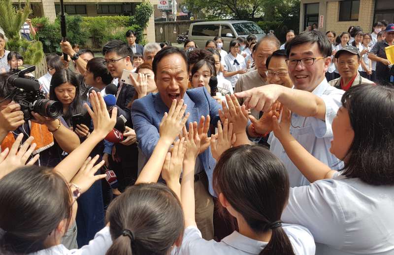 郭台銘走進新竹市私立曙光女中,立即受到女同學們列隊擊掌的熱情歡迎。(圖/方詠騰攝) 郭台銘走進新竹市私立曙光女中,立即受到女同學們列隊擊掌的熱情歡迎。(圖/方詠騰攝)
