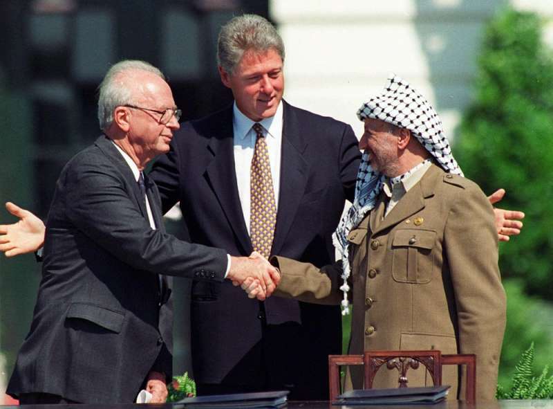 1994年,以色列總理拉賓(Yitzhak Rabin,左)及巴勒斯坦自治政府前主席阿拉法特(Yasser Arafat,右)在美國時任總統柯林頓的搓合下,握手言談。(AP) 1994年,以色列總理拉賓(Yitzhak Rabin,左)及巴勒斯坦自治政府前主席阿拉法特(Yasser Arafat,右)在美國時任總統柯林頓的搓合下,握手言談。(AP)